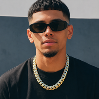 Man in sunglasses wearing a gold Cuban link chain - Showtime Gems