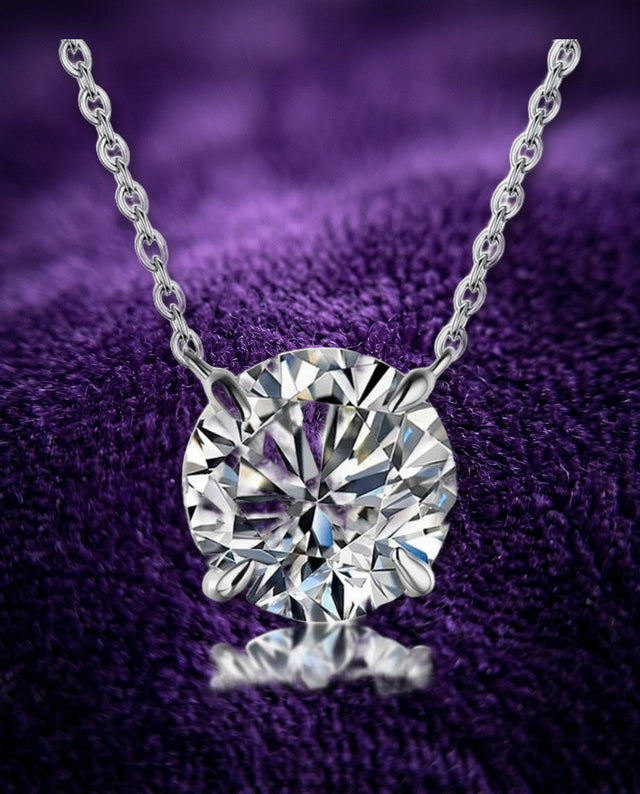 Moissanite solitaire pendant on royal purple velvet, macro — Showtime Gems
