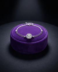 Moissanite tennis bracelet with halo center stone on royal purple velvet — Showtime Gems