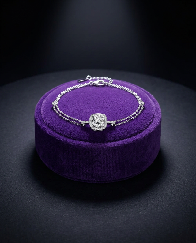 Moissanite tennis bracelet with halo center stone on royal purple velvet — Showtime Gems
