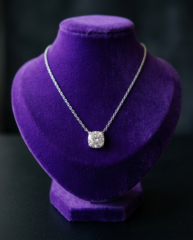 Cushion-cut moissanite pendant necklace on royal purple velvet bust — Showtime Gems