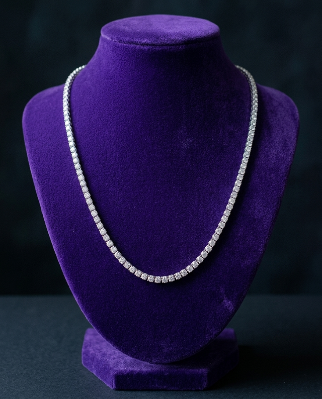 GRA certified moissanite tennis necklace on royal purple velvet bust — Showtime Gems