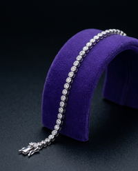 2mm bezel moissanite tennis bracelet on royal purple velvet ramp — Showtime Gems