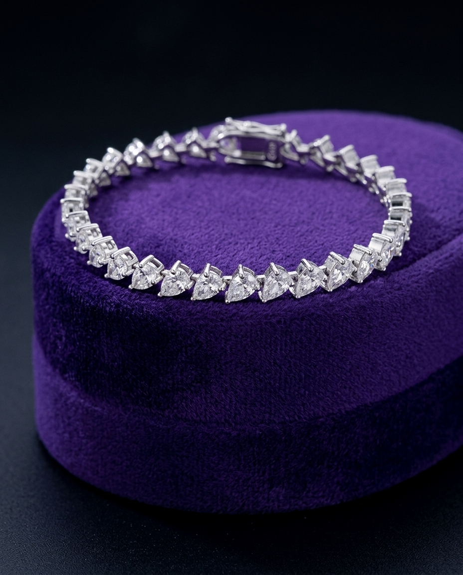 Pear-cut moissanite tennis bracelet on royal purple velvet ramp — Showtime Gems