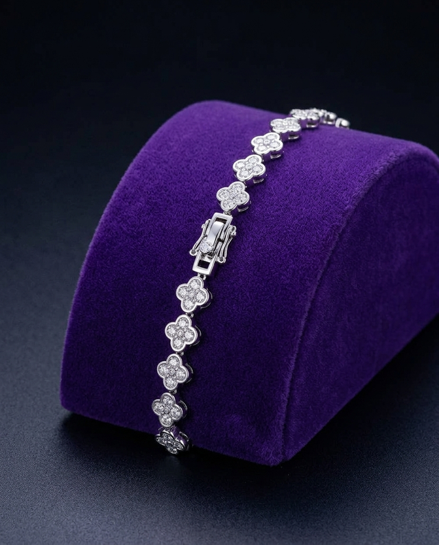 Four-leaf clover moissanite bracelet on royal purple velvet ramp — Showtime Gems