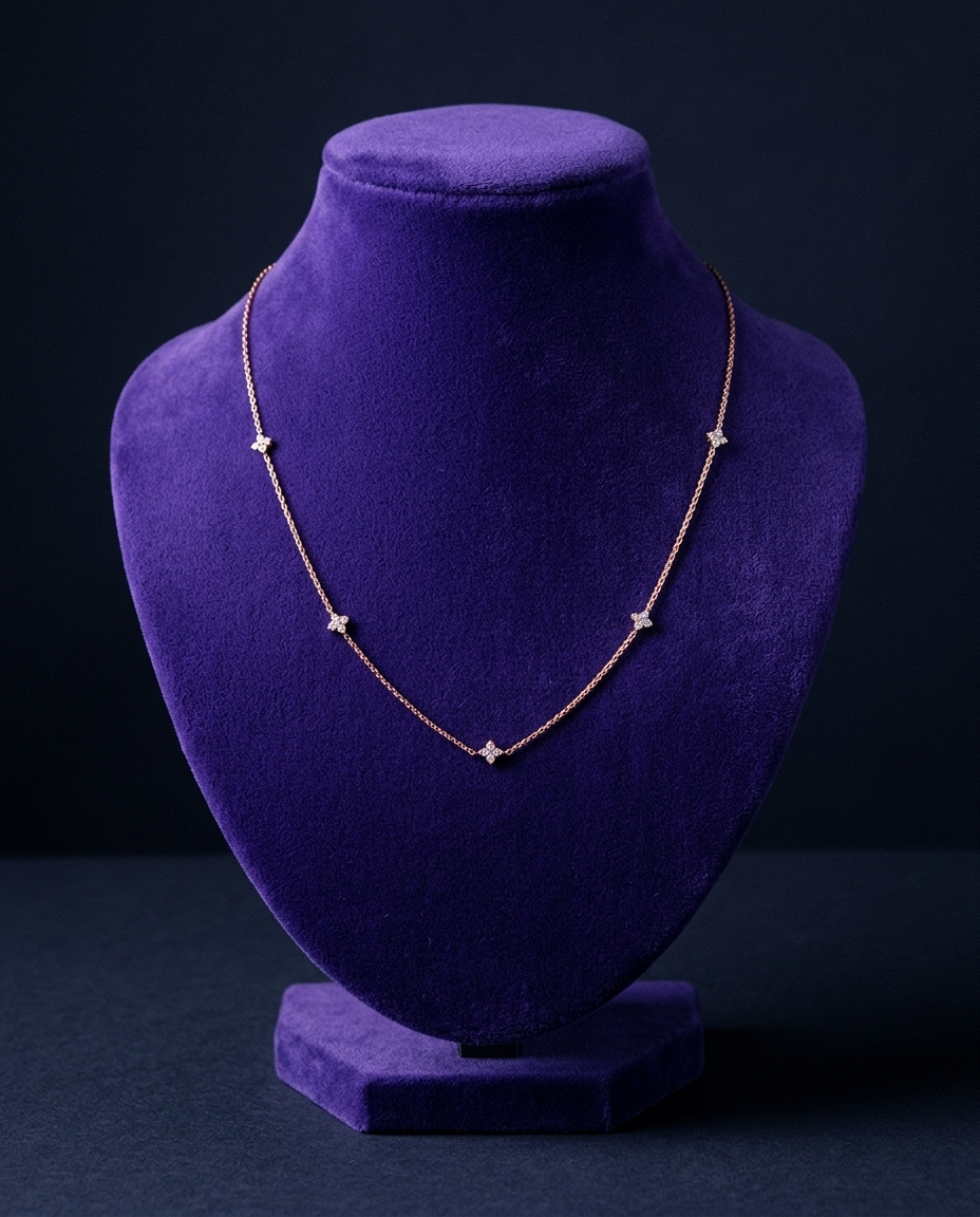 Rose gold clover-station moissanite necklace on royal purple velvet bust — Showtime Gems