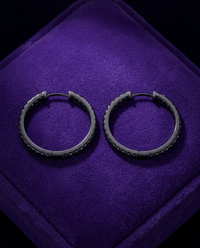 Black Moissanite Hoop & Huggie Earrings (925 Silver) earrings on royal purple velvet — Showtime Gems